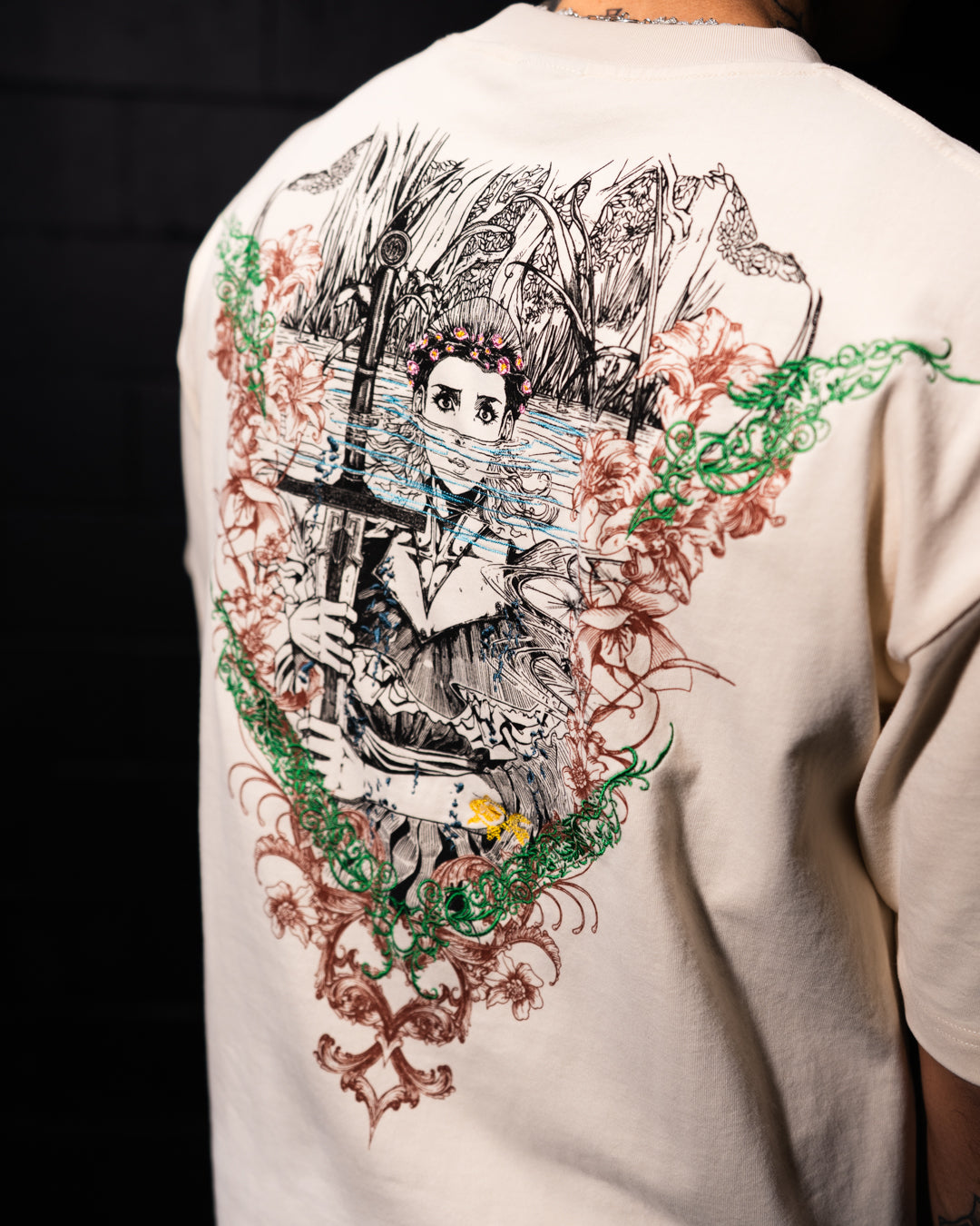 White t-shirt with a detailed graphic design on the back.