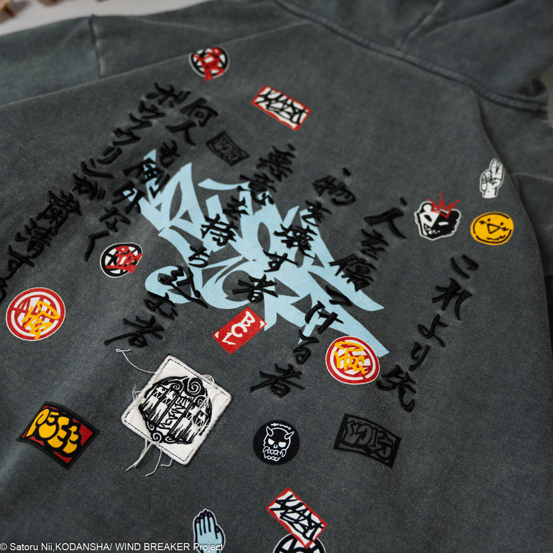 Dark gray hoodie with various embroidered patches.