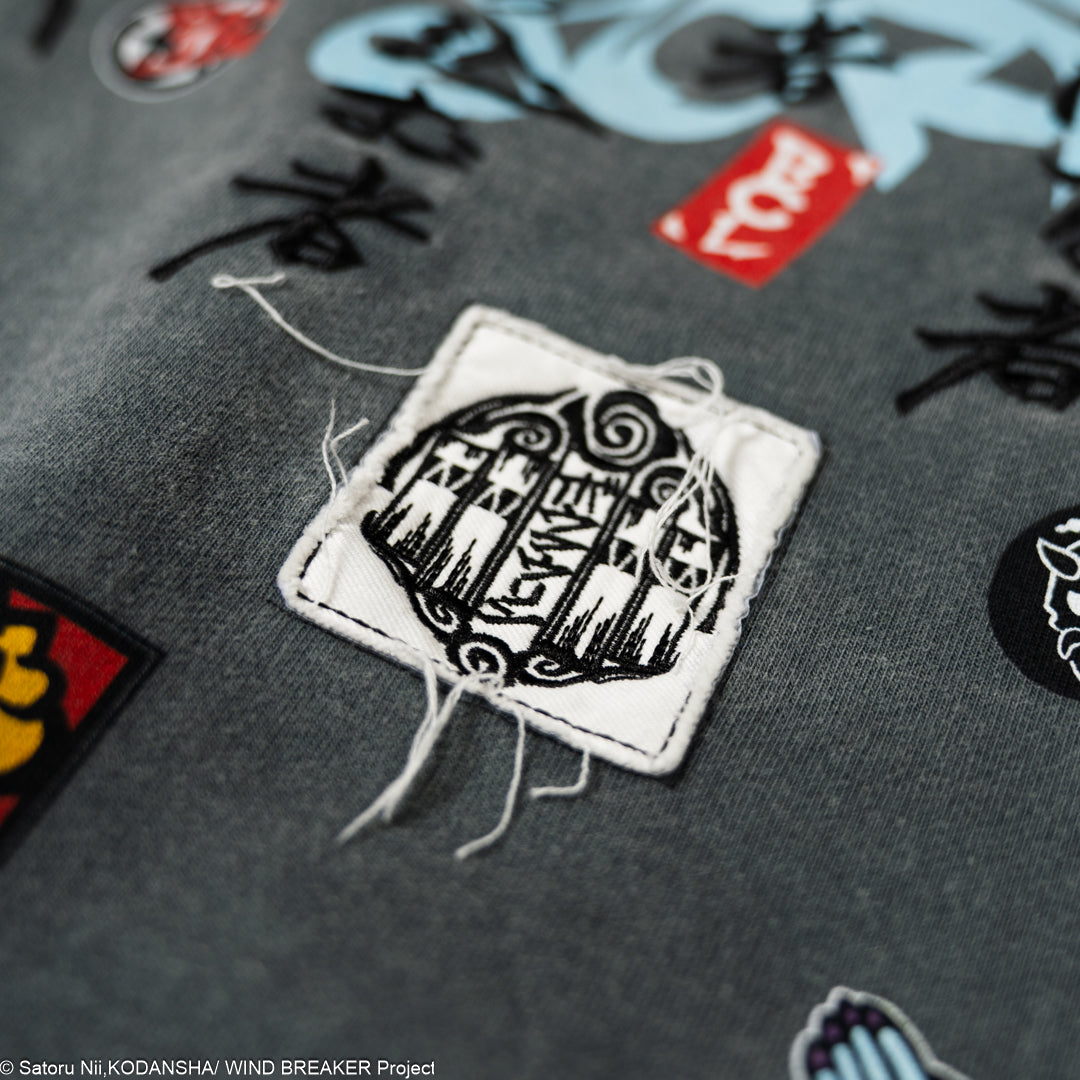 Close-up of a patch on a gray hoodie.
