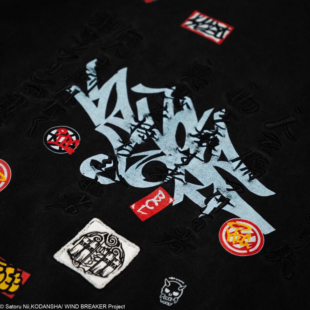 Black shirt with various logos and text on a dark background