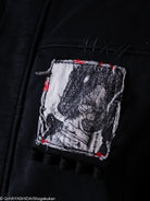 Embroidered patch of a character on a black jacket. 