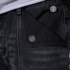 Black denim jeans with cherry blossom floral embroidery and armored inspired paneling. 