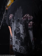 Black t-shirt with a graphic design on the back, featuring a character and mushrooms.