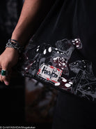 Black t-shirt with mushroom and patch detail being held to show detail. 