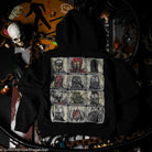 Black hoodie with multiple sewn patch designs on the back, in a dark setting with various objects around.