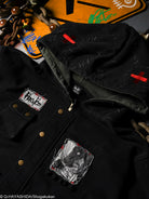 Black jacket with patches and bronze buttons. 