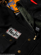 Close-up of a black jacket with a patch and visible brand name.