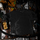 Black t-shirt with a design on a dark background with various objects