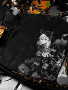 Black shirt with a white graphic design of a character on a dark background