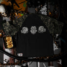 Black t-shirt with white printed character designs on a dark background with various items.