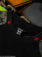 Black t-shirt with red logo and visible brand label on collar.  