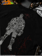 Black t-shirt with a white graphic design of a character on a dark background.