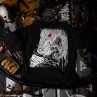 Black t-shirt with a white lizard design on a dark background