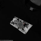 Black t-shirt with a box graphic design and brand label on a dark background