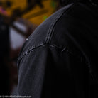 Close-up of a dark shirt with blurred background