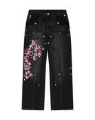 Black denim jeans with cherry blossom floral embroidery and armored inspired paneling. 
