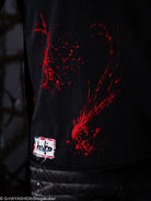 Black t-shirt with red graphic design and a visible brand label on a dark background