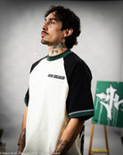 Person wearing a black and white baseball shirt with 'WIND BREAKER' text, standing against a gray background.