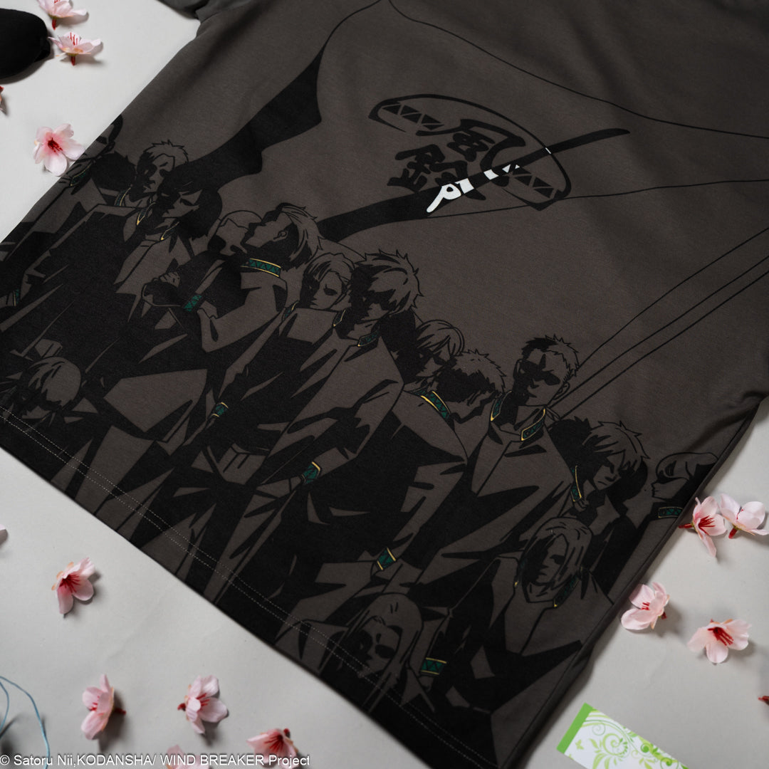 Grey t-shirt with anime character design on a white surface with pink flowers