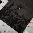 Grey t-shirt with anime character design on a white surface with pink flowers