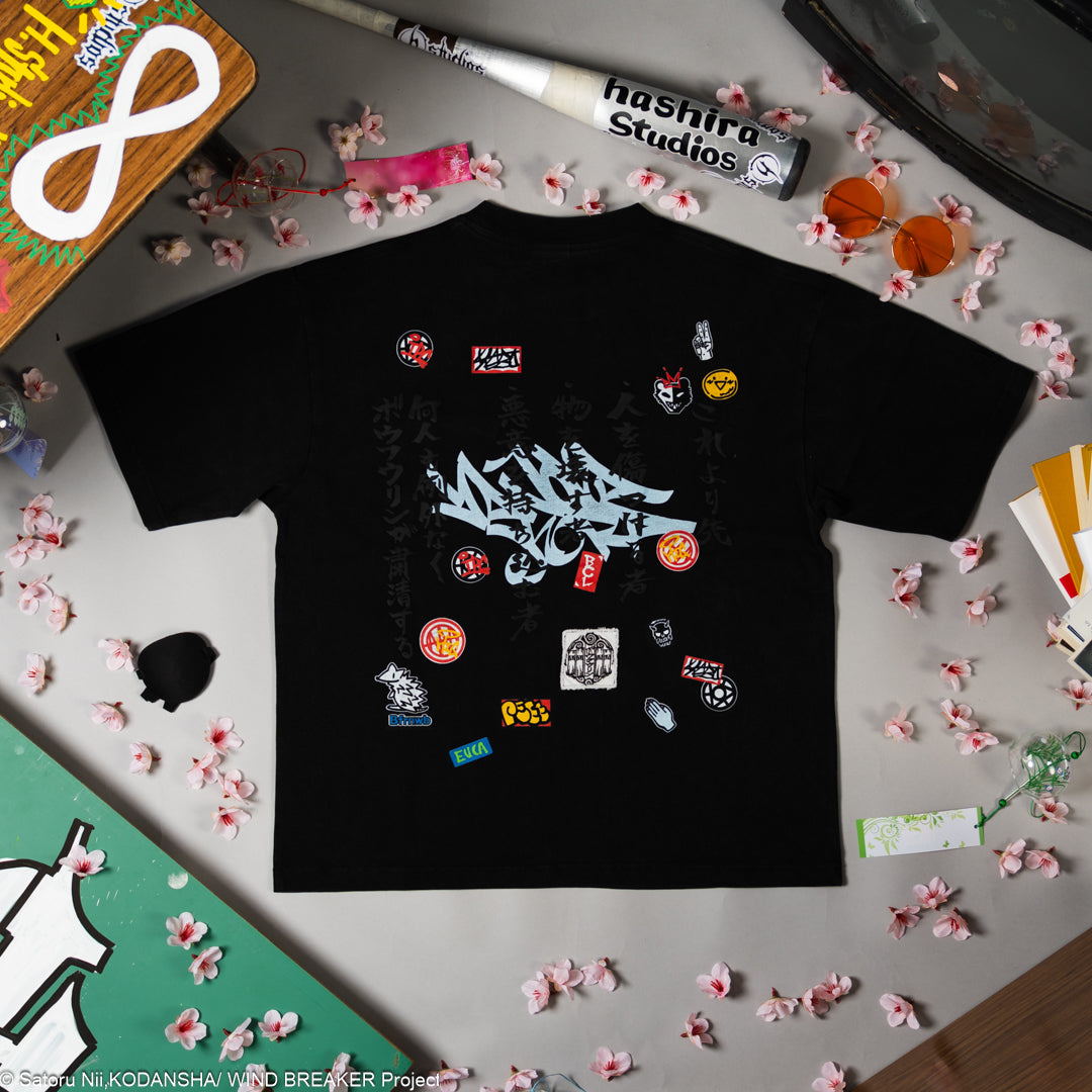 Black t-shirt with various colorful patches on a surface with decorative items