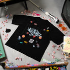 Black t-shirt with colorful graphics on the back. 