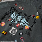 Dark gray hoodie with various embroidered patches. 