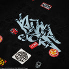 Black shirt with various logos and text on a dark background