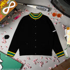 Black jacket with green and yellow accents on a gray surface with decorative items.
