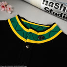 Green and yellow plaid collar knit jacket on a black background. 
