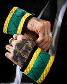 Close-up of hand opening of knit jacket  with green and yellow accents. 