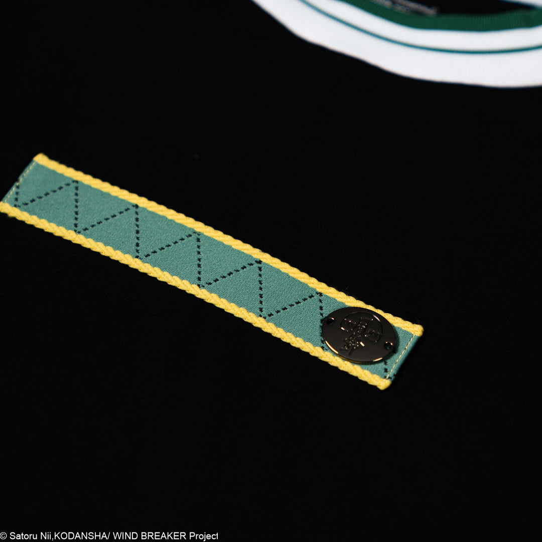 Close-up of a green and yellow woven strap with a button on a black background
