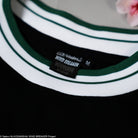 Close-up of a green and white striped shirt with a label on a black background